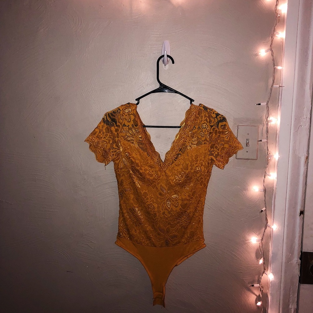 Lacey gold body suit.